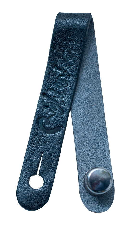 Attache-courroie, cuir, pour guitare ou basse acoustique, se place sous les cordes juste avant le sillet de tête, noir